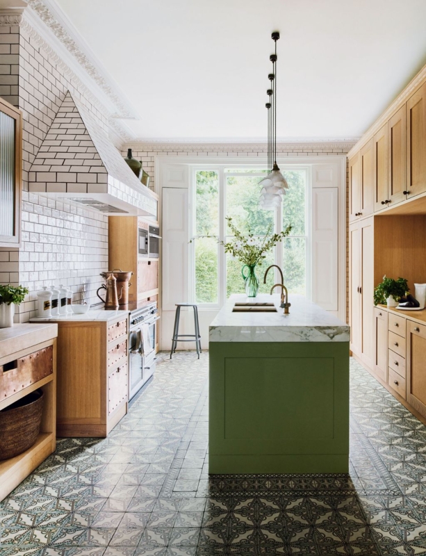 Eclectic Kitchen with Ornate Patterned Floor Tiles and Green Island