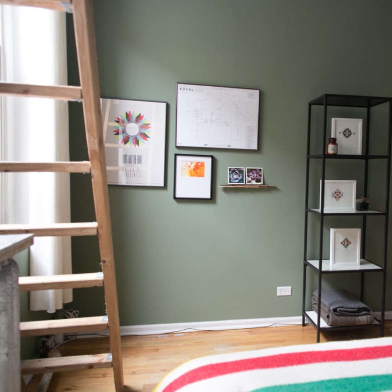 Eclectic Living Room with Black Metal Shelving and Leaning Ladder