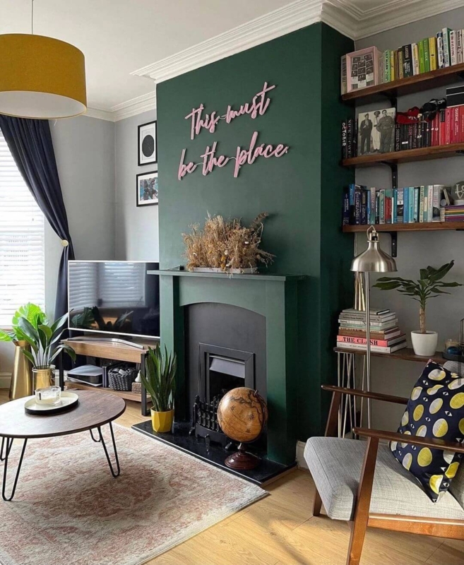 Eclectic Living Room with Emerald Green Accent Wall and Neon Script Art