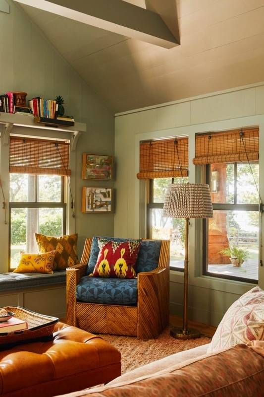Eclectic Reading Nook with Sage Green Paneling and Rattan Armchair