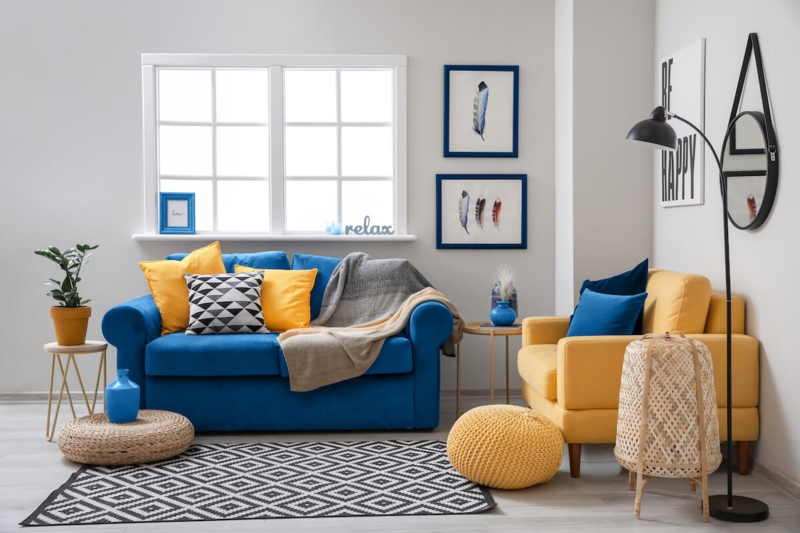 Eclectic Sofa with Mixed Seating Colors and Geometric Rug