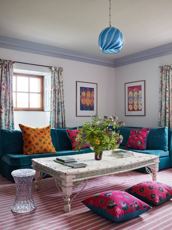 Eclectic Teal Sectional with Pink Striped Rug and Whitewashed Table