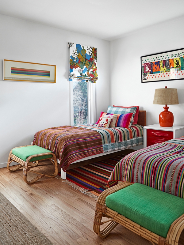 Eclectic Twin Bedroom with Colorful Striped Bedding and Rattan Stools