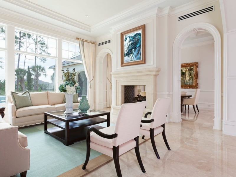 Elegant Formal Living Room with Arched Doorway & Marble Tile Floors