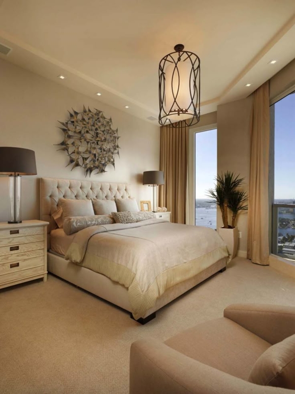 Elegant High-Rise Master Suite with Tufted Bed and Sunburst Art