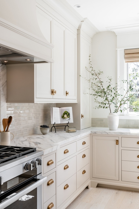 Elegant Off-White Inset Kitchen Cabinets with Brass Hardware Accents