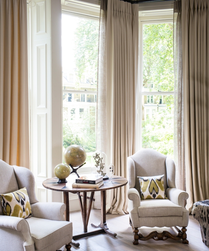 Elegant Reading Nook: Paired Wingback Chairs and Ikat Accent Pillows