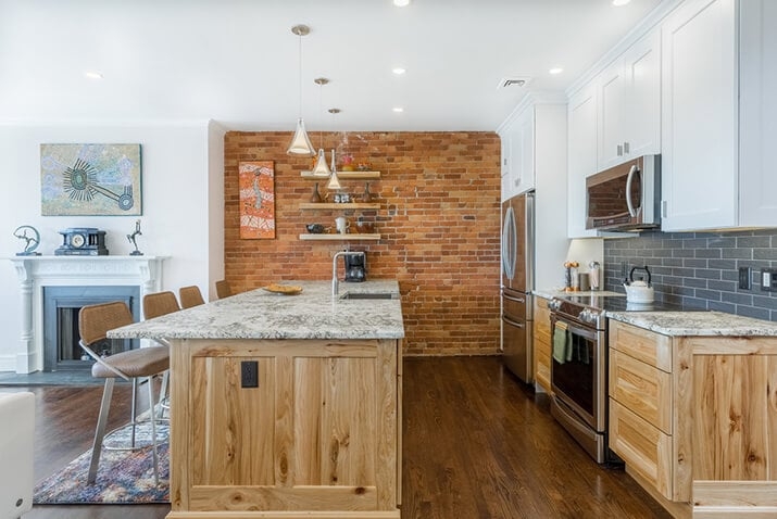 Exposed Brick Kitchen Accent Wall with Floating Shelves