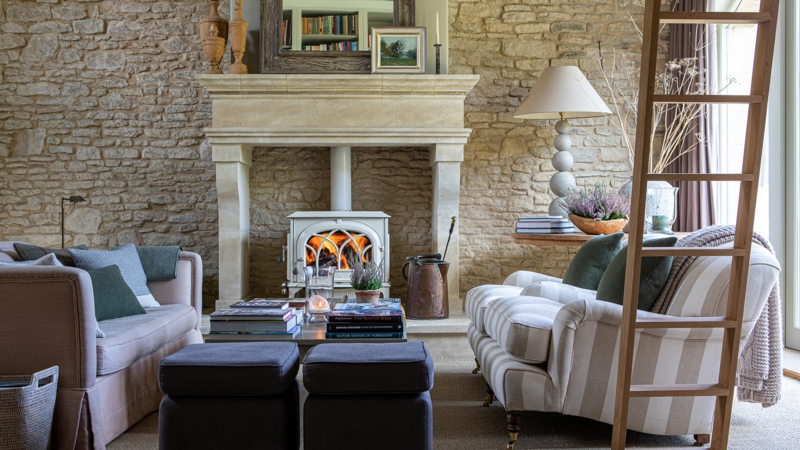 Exposed Stone Wall Living Room with Rustic Wood Burning Stove