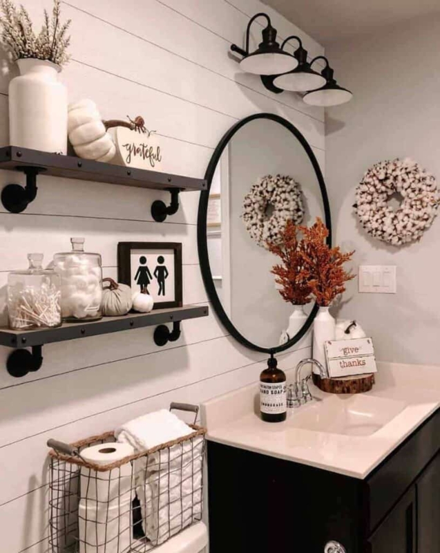 Farmhouse Bathroom with shiplap walls and industrial pipe shelving.
