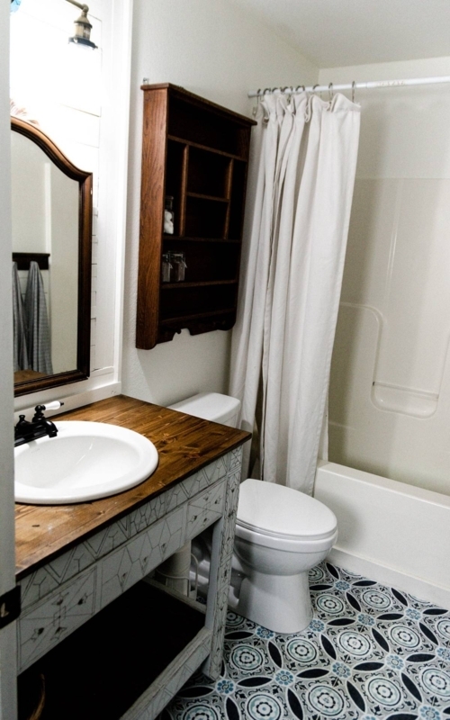 Farmhouse Bathroom with Wood Countertop Vanity and Blue Geometric Floor