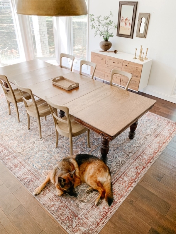 Farmhouse Dining Room with Weathered Rug and Turned Table Legs