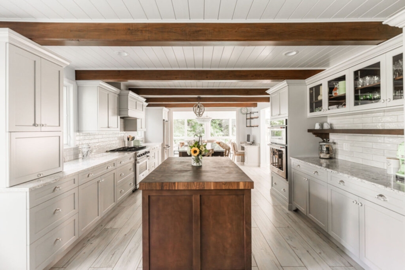 Farmhouse Kitchen with Dark Wood Beams and Butcher Block Island