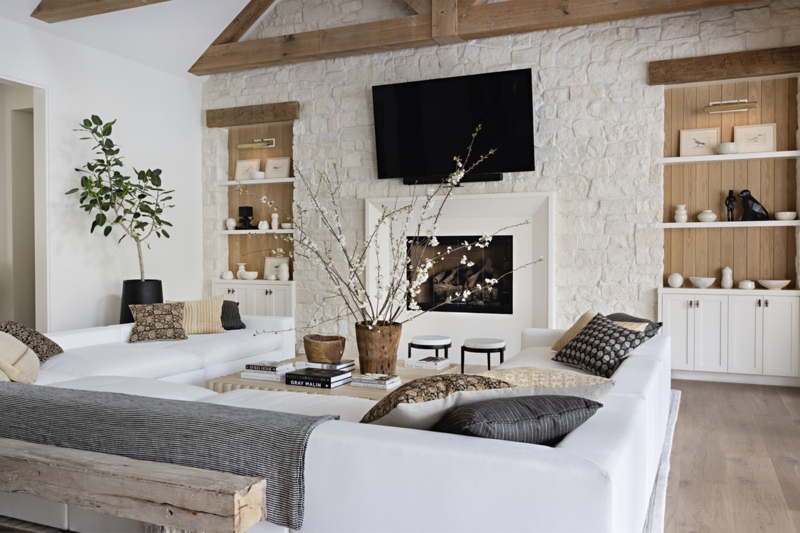 Farmhouse Living Room Design with White Stone Fireplace and Exposed Beams