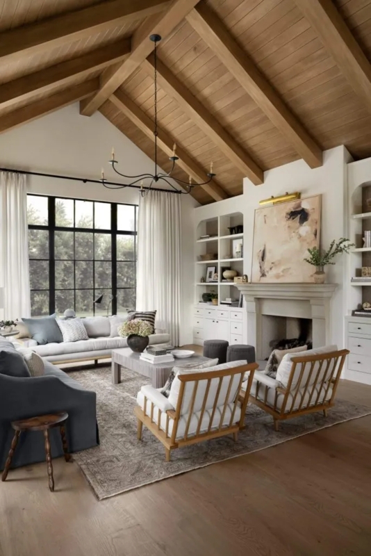 Farmhouse Living Room with Arched Built-In Shelves & Beamed Ceiling