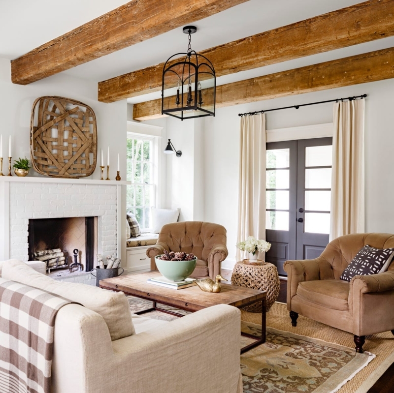 Farmhouse White Brick Fireplace Design with Tufted Brown Armchairs