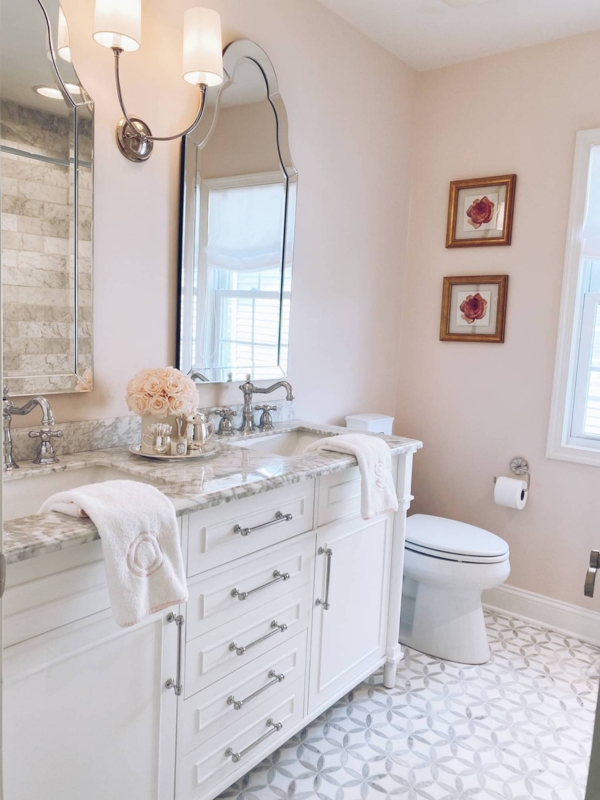 Feminine Bathroom Vanity with soft pink walls and ornate arched mirrors.