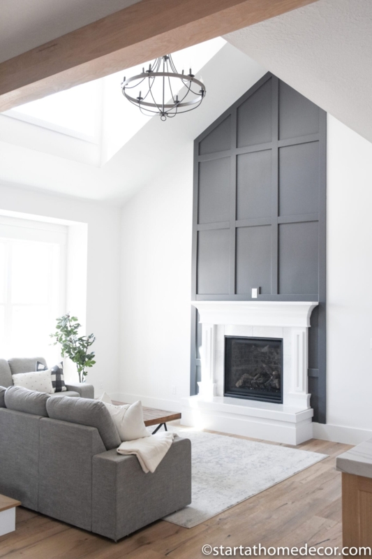 Fireplace with Dark Board and Batten Accent Wall and Vaulted Ceiling