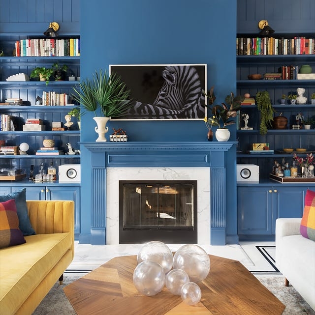 Fireplace with Monochromatic Blue Wall and Maximalist Mustard Yellow Sofa