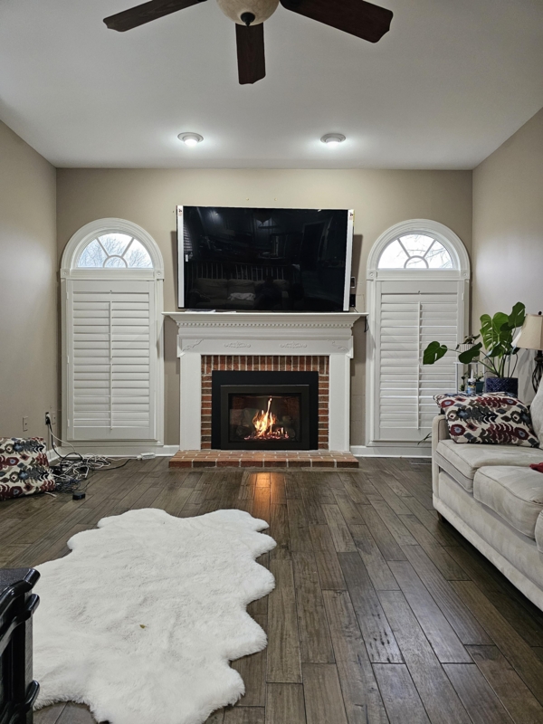 Fireplace with Traditional Brick and Arched Windows with Shutters