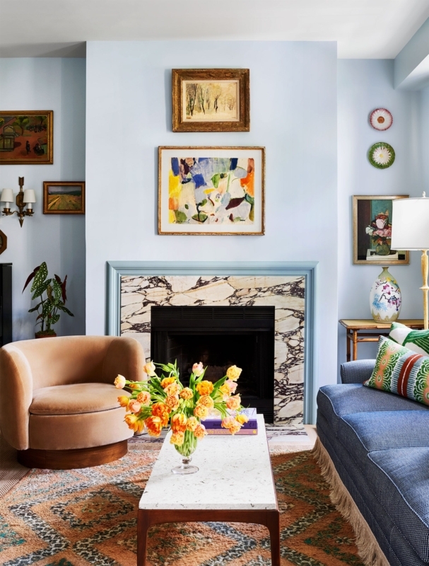 Fireplace with Veined Marble Surround and Eclectic Fringe Trim Sofa