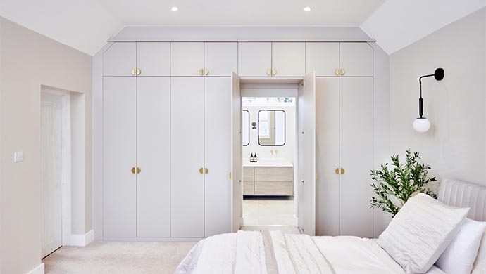 Fitted Wardrobe with Hidden Ensuite Door and Brushed Brass Hardware