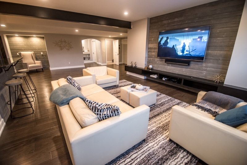 Floating Media Shelf on Grey Wood Plank Wall in Basement Lounge