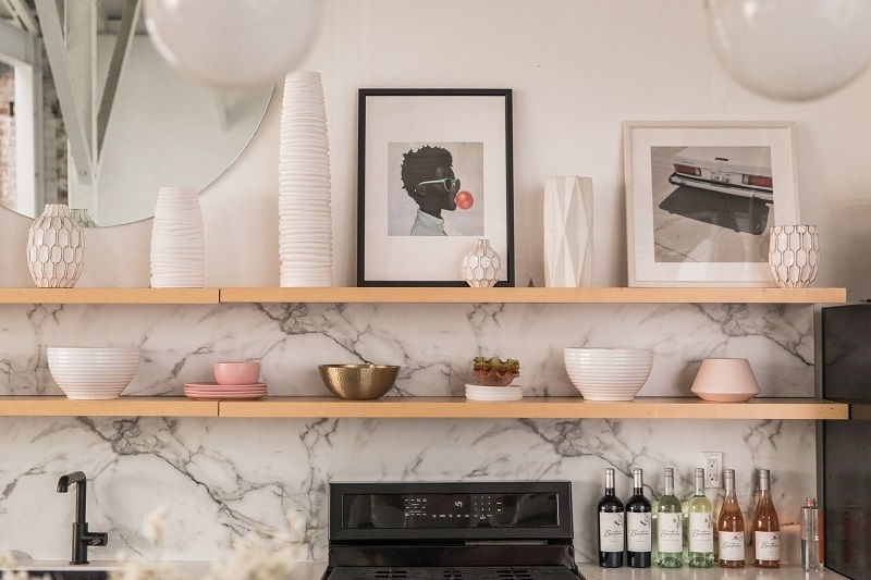 Floating Shelves over Marble Backsplash with Curated Ceramic Decor