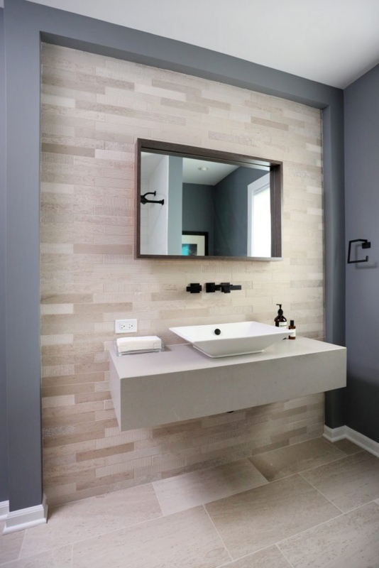 Floating Vanity: Stone Countertop with Textured Tile Accent Wall