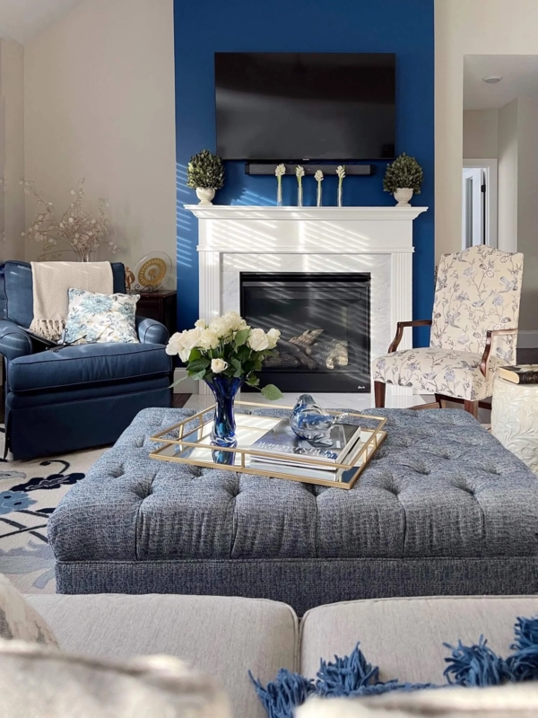 Formal Living Room featuring Tufted Ottoman & Fireplace Mantel