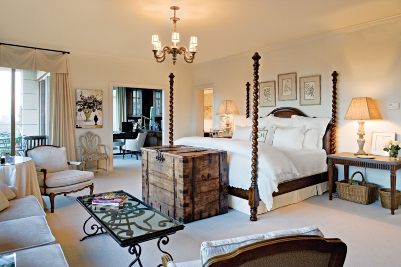 Four-Poster Bed with Spiral-Turned Posts and Rustic Storage Trunk