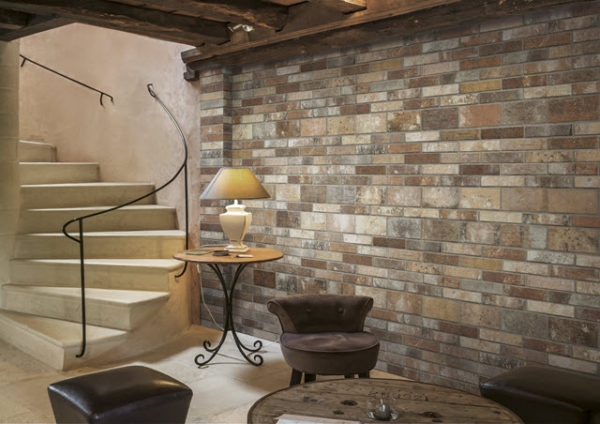 Foyer: Rustic Stone Staircase with Curved Metal Handrail and Brick Wall