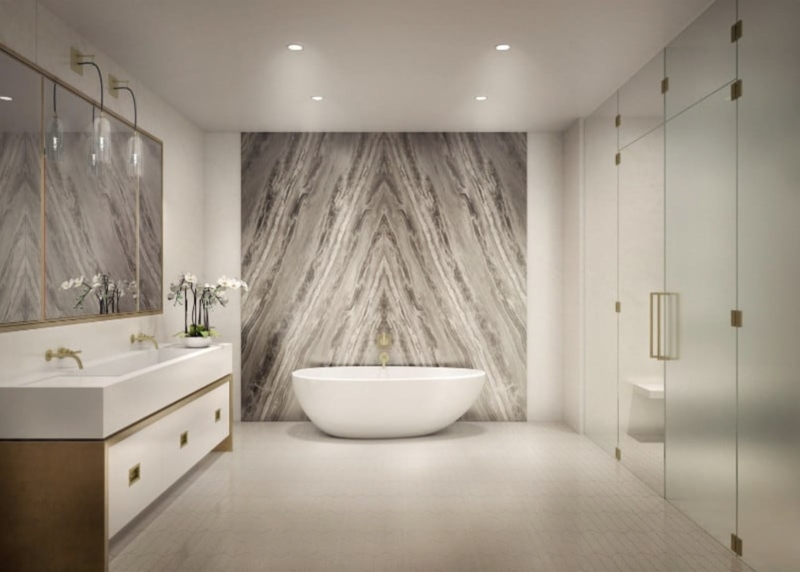 Freestanding Bathtub with Book-Matched Stone Wall & Gold Vanity in Luxury Bath