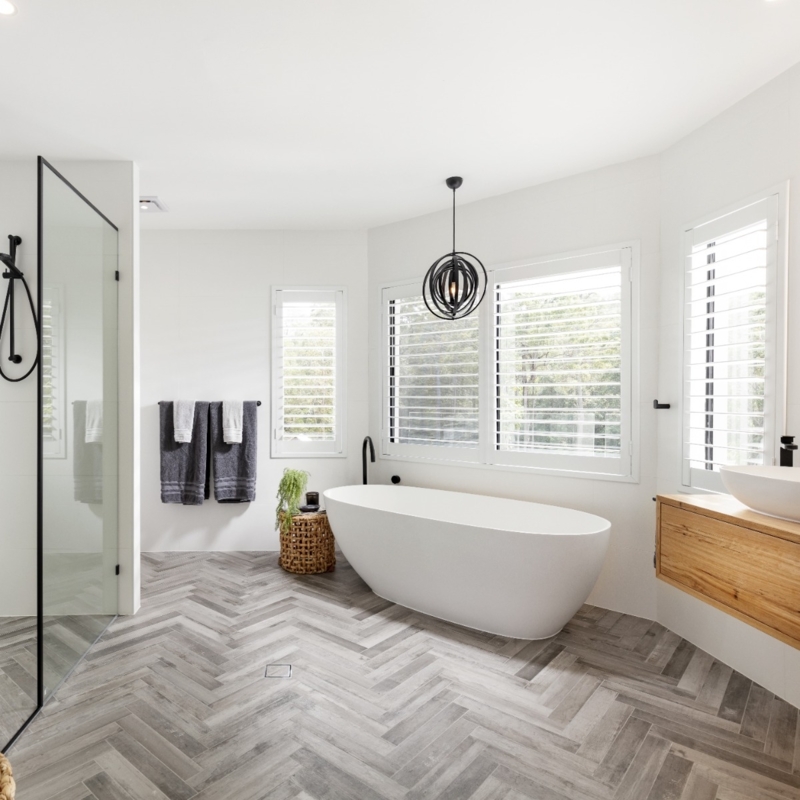 Freestanding Bathtub with Grey Herringbone Tile & Black Pendant