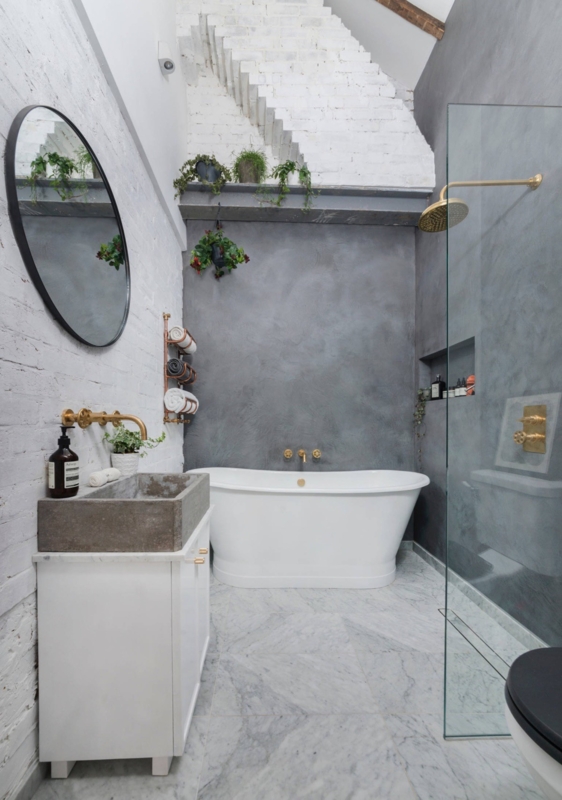 Freestanding Soaking Tub with Gold Hardware and Mixed Wall Textures