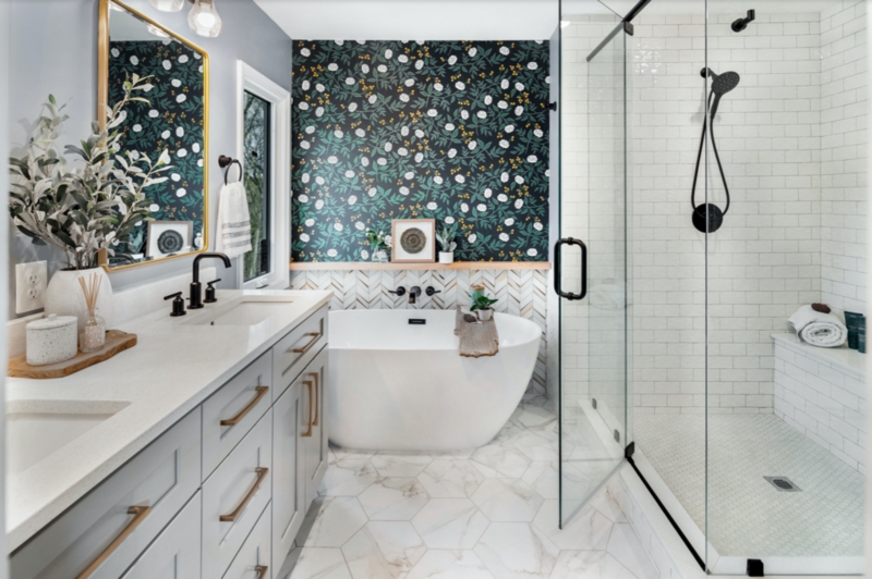 Freestanding Tub with Dark Floral Accent Wall & Herringbone Tile