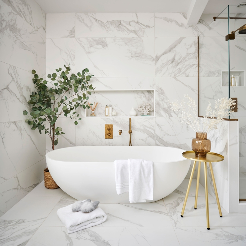 Freestanding Tub with Marble Tiles and Gold Accents