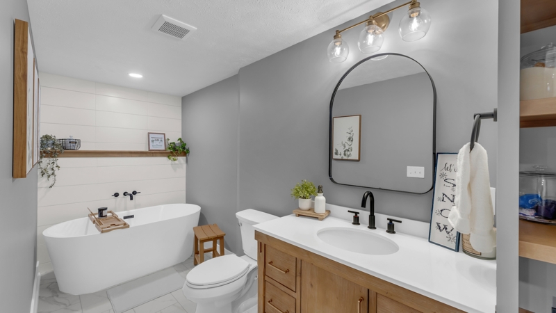 Freestanding Tub with Wood Stool in Bathroom with Shiplap Accent Wall