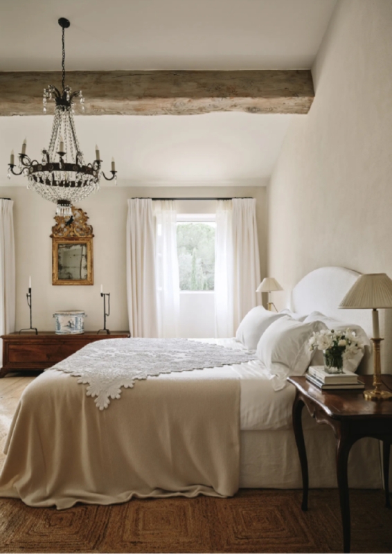 French Country Bedroom with Reclaimed Wood Beam and Crystal Chandelier
