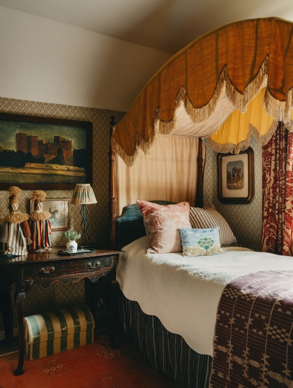 Fringed Ochre Canopy Bed in Maximalist Bedroom with Eclectic Wallpaper