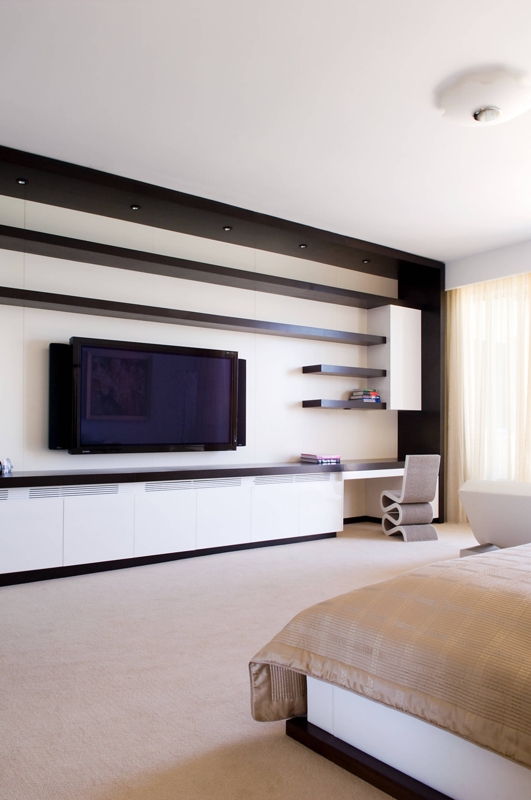 Full Wall Built-in Media Unit with Sculptural Desk Chair and Shelving