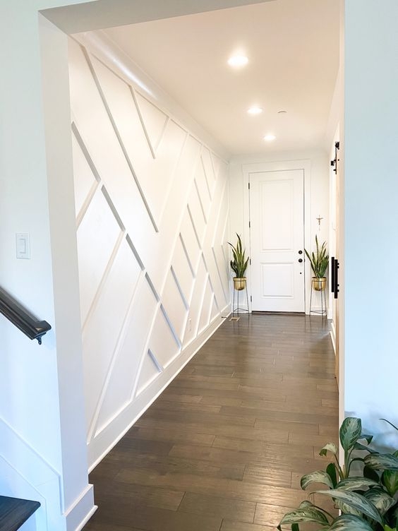 Geometric Wall Paneling in Hallway featuring Dark Wood Floors