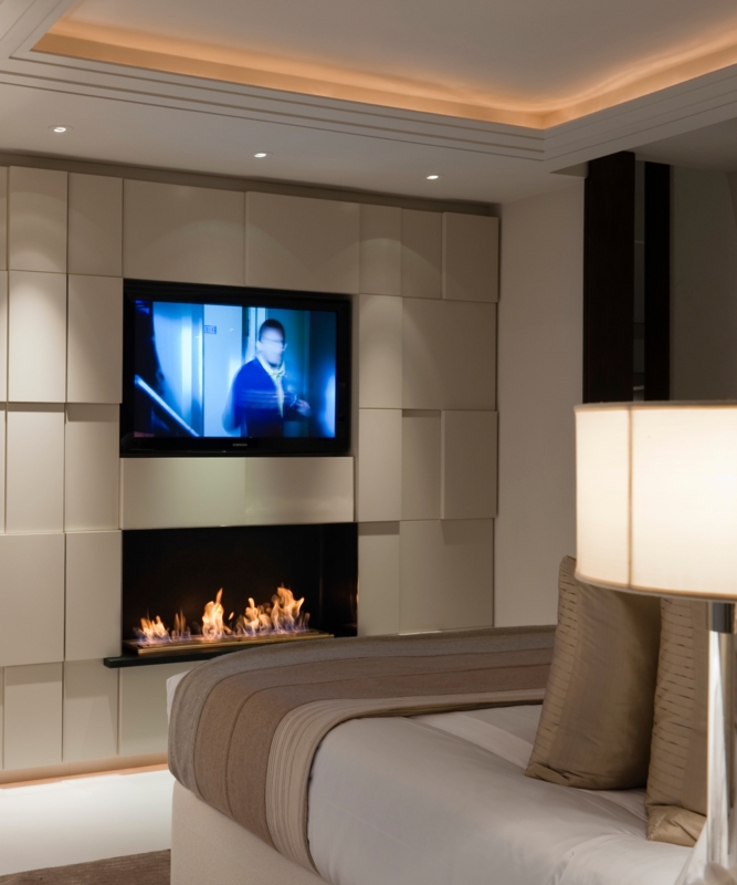 Geometric Wall Paneling with Integrated Fireplace and Recessed TV Nook