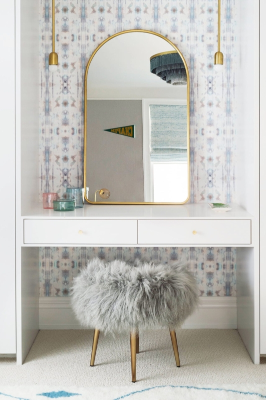 Glam Makeup Vanity in Patterned Wallpaper Niche with Arched Gold Mirror