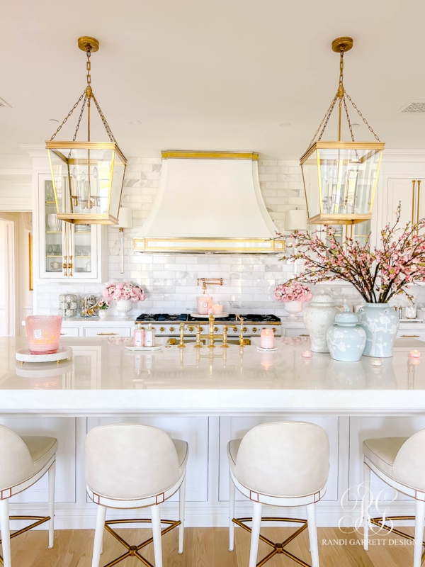 Glam White Kitchen with Gold Hardware and Oversized Lantern Lights