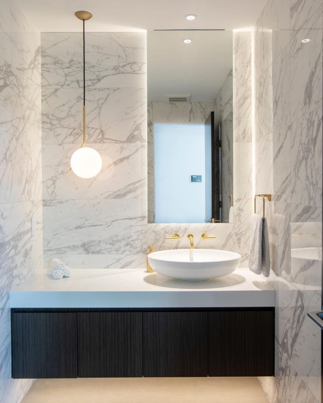 Globe Pendant: Minimalist Bathroom with Backlit Mirror and Marble
