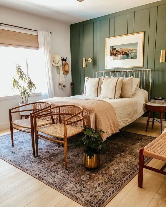 Gold Metal Bed Frame in Sage Green Bedroom with Woven Chairs