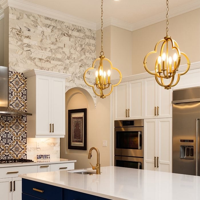 Gold Quatrefoil Lantern Pendant Lights Over Navy Kitchen Island