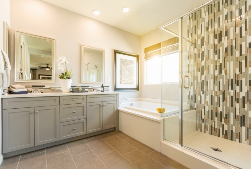Gray Double Vanity with Vertical Mosaic Tile and Built-In Tub