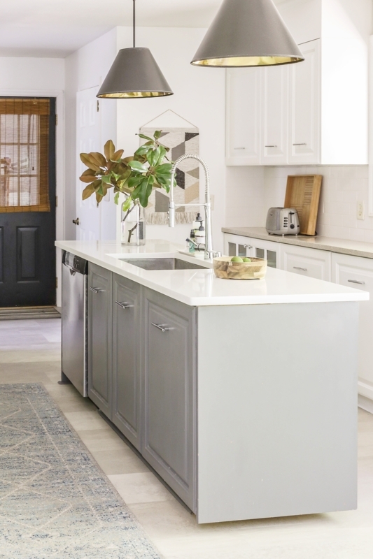 Gray Kitchen Island with White Top and Large Black Cone Pendant Lights